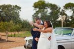 Having fun popping champagne at a Preston One Events Wedding captured by Dallas Wedding Photographer, Sarah Mae